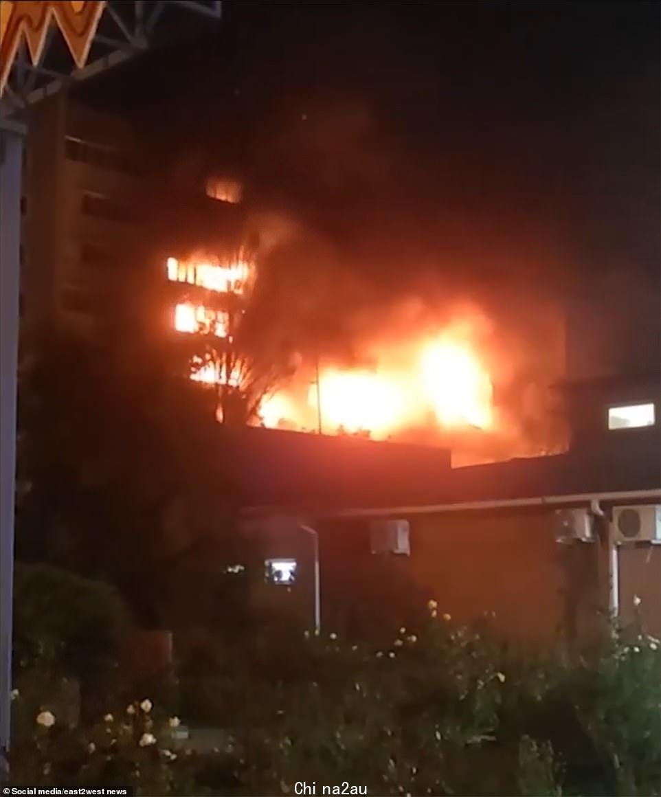 可以看到公寓楼的几层楼s 巨大的火焰穿过住宅楼