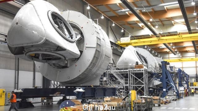 Employees work at the assembly line of a wind turbine produced for France's future first wind farm off Saint-Nazaire, at the General Electric plant of Montoir-de-Bretagne, Britany, on September 15, 2020.