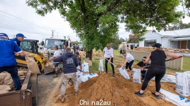 那些房屋没有被围墙保护的人已经成群结队地帮助社区保护市中心。图片：NCA NEwswire/Jason Edwards