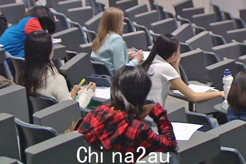 Students sitting in lecture hall.