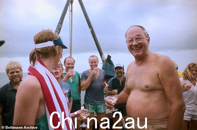 Divers from the Key West Treasure Salvors toast 公司总裁 Mel F伊舍尔,对,关于在 1985 年西班牙阿托查号沉船中发现数百条银条