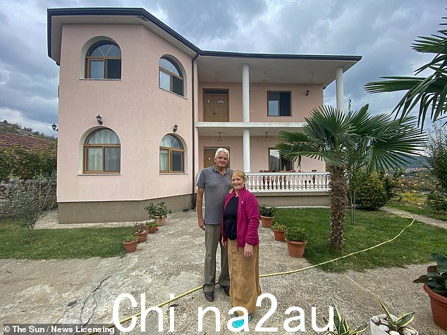 Sait Shabaj 和他的妻子 Xheride 在他们用非法进入英国的儿子寄来的钱建造的阿尔巴尼亚粉红色房屋前摆姿势