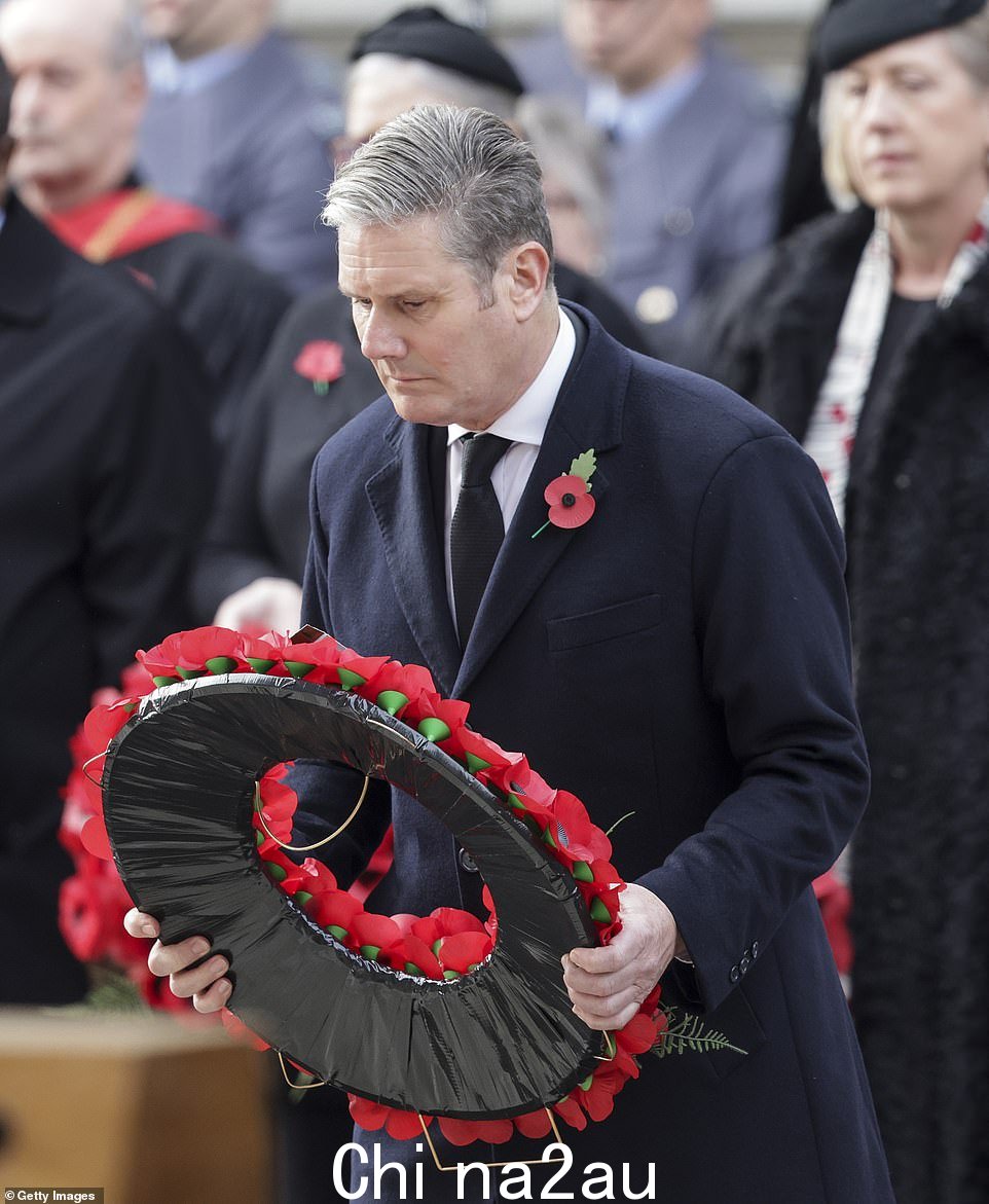 Keir Starmer 爵士庄重地看着其他花圈,他走上前代表工党放下他的花圈