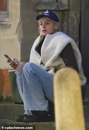舒适:Emma 为造型添加了蓝色帽子和黑色运动鞋