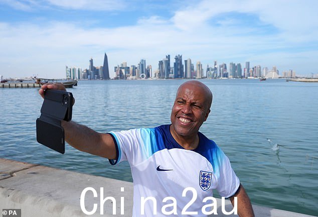 捕捉瞬间:一名英格兰球迷周二在多哈的滨海路快速拍照,因为英格兰和威尔士之间的仇恨比赛之前的集结