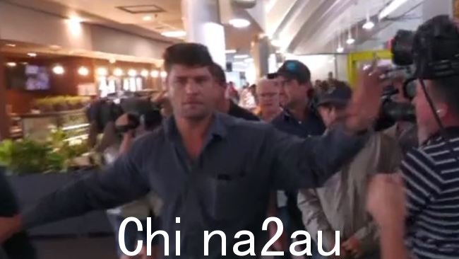 马特赖特的保镖在达尔文的火热场面中与等候的媒体发生冲突机场,内陆牧马人明星抵达顶端,面临与致命的直升机坠毁有关的指控。图片:Sky News Australia