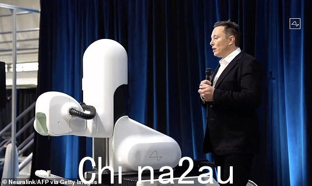 这段从在线 Neuralink 直播中截取的视频显示,Elon Musk 在 2020 年 8 月 28 日的 Neuralink 演示中站在手术机器人旁边