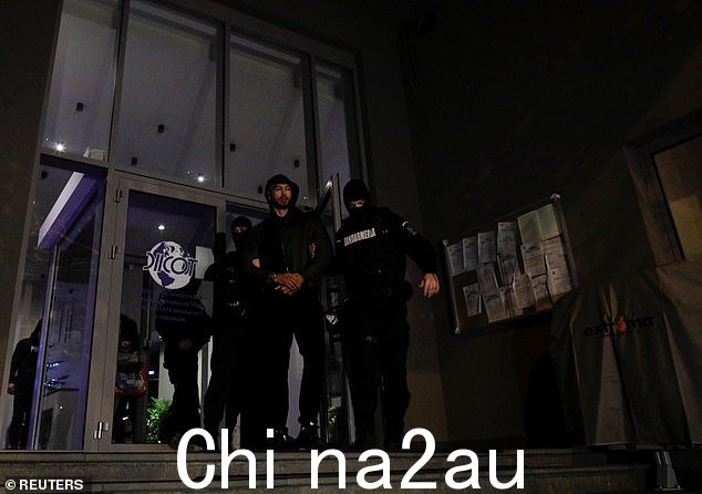 Andrew Tate 在布加勒斯特有组织犯罪和恐怖主义调查局总部外由警察护送