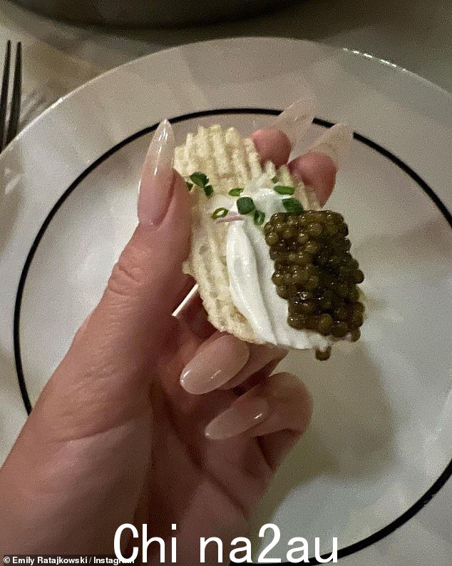 好吃!还有一些美味的食物,模特展示了一种融合了高雅文化和低俗文化的小吃。她展示了带有酸奶油和细香葱的脊状薯片,以及大量鱼子酱以增加咸味。