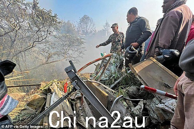 周日,救援人员聚集在博卡拉坠机事故现场