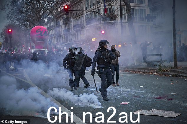 法国防暴警察星期四在示威活动中穿过巴黎的催泪瓦斯云