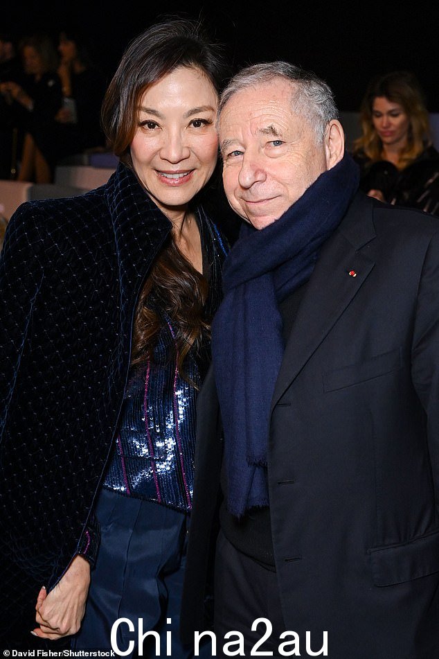  Sharp：Michelle 还与 Jean Todt 在时装秀上合影，Jean Todt 身穿黑色西装外套和黑色长裤，看起来很潇洒