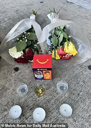 周五在水泥地上放了两束鲜花和蜡烛,以纪念蹒跚学步的孩子