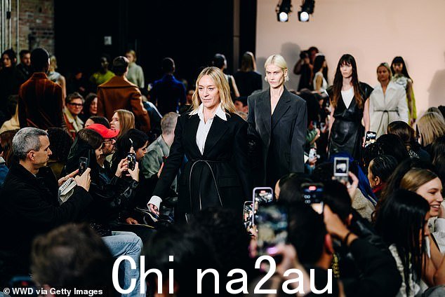 大摇大摆:她衬衫顶部的纽扣未系,领子翻到夹克前面