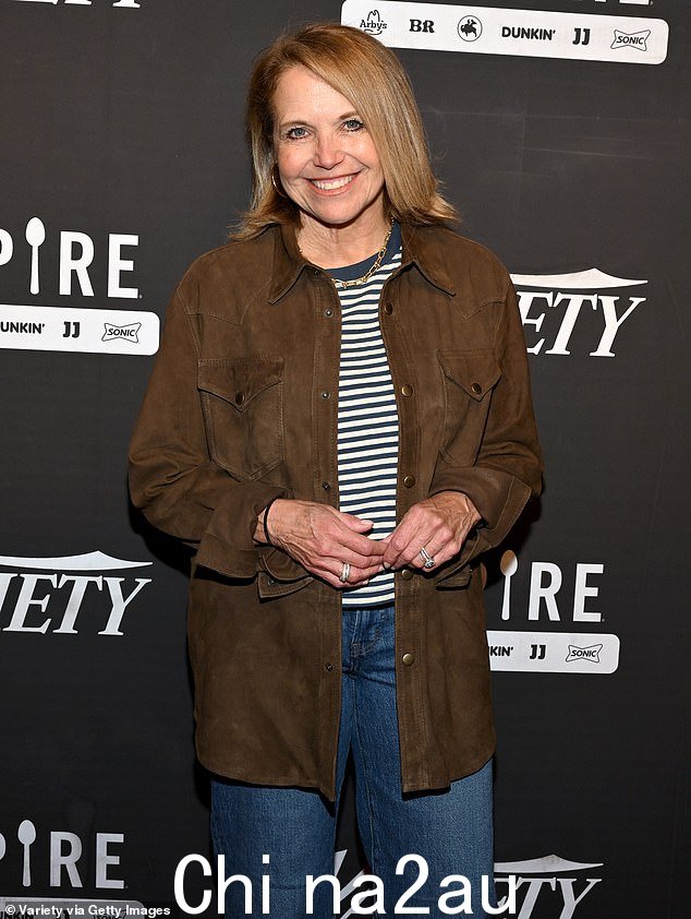 保持舒适:Katie Couric 在棕色纽扣夹克下面穿了一件条纹 T 恤,搭配蓝色牛仔裤