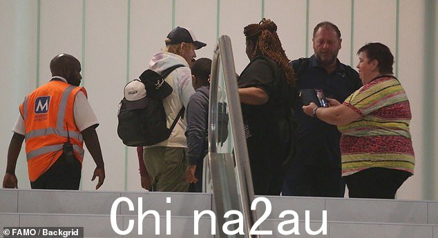 Ed looked delighted to chat with a group of fans who stopped him while he was being escorted through the departure area