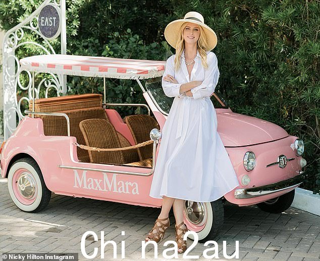 Cute car: The fashion author added a flirty straw hat with a black ribbon as her long blonde hair was worn down. Her shoes were brown strappy heels