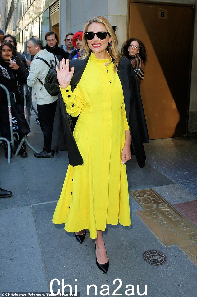 欢快:伊丽莎白·奥尔森 (Elizabeth Olsen) 身穿亮黄色中长裙,袖子上有黑色纽扣,在人群中脱颖而出,周二抵达纽约市的今日秀