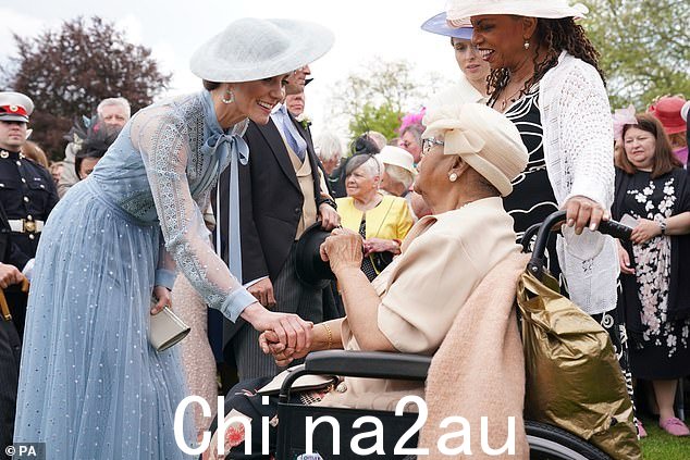 当凯特向 Grandison 女士问好时,她握着这位 93 岁老人的手,边微笑边聊天