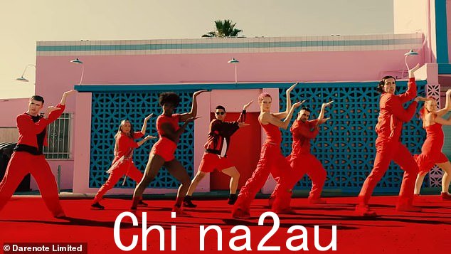 Dancing away: Her backing dancers are claded in similar colours