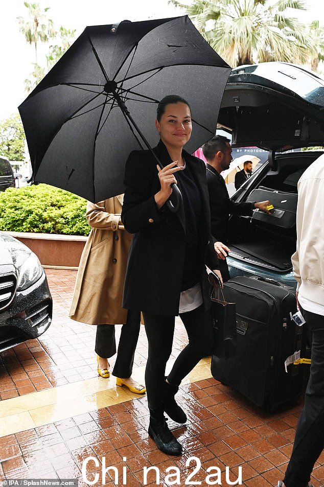 阿德里亚娜·利马,41 岁,到达标志性酒店时用雨伞保护自己免受天气影响