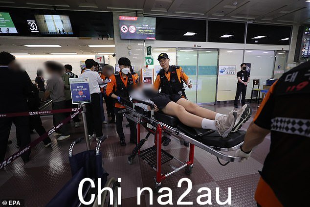 救援人员在大邱国际机场运送担架上的学生