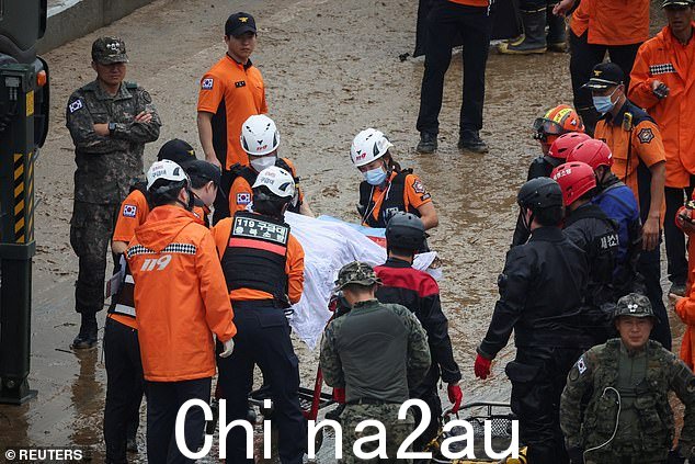 2023 年 7 月 16 日,救援人员在清州被洪水淹没的河流淹没的地下通道附近移动搜救行动中发现的受害者尸体