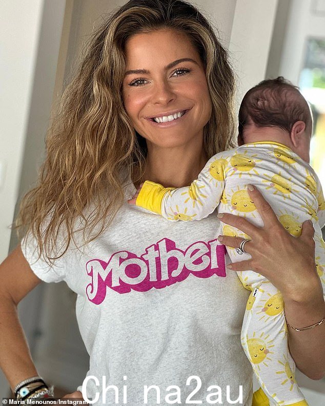 更新:周三,Menounos 在 Instagram 上分享了一张她穿着灰色 T 恤的照片,上面用粉红色的芭比字体写着“妈妈”,同时抱着孩子面向着孩子远离相机