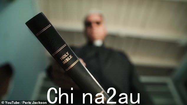 看它!可以看到牧师挥舞着一本皮革装订的《圣经》