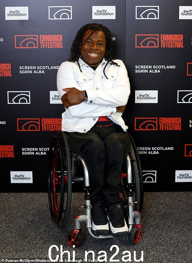喜气洋洋:Ade Adepitan 穿着牛仔夹克,笑容灿烂