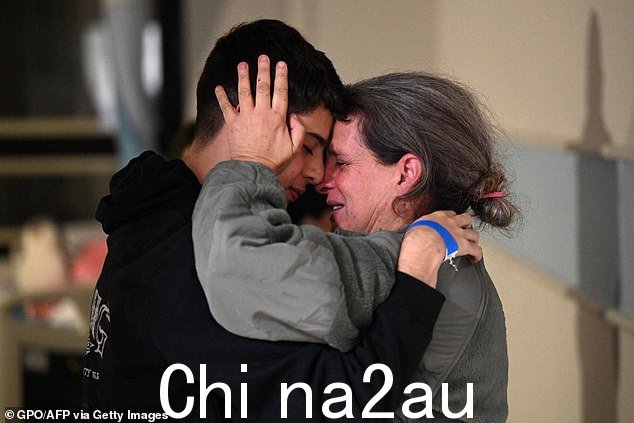 图:莎朗·赫兹曼·阿维格多里 (Sharon Hertzman Avigdori) 今天与女儿一起从哈马斯囚禁中获释后拥抱她的儿子