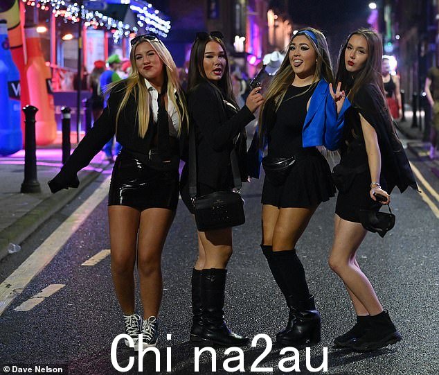一群女孩拿着假装手枪在镜头前摆出姿势,享受维冈的节日之夜