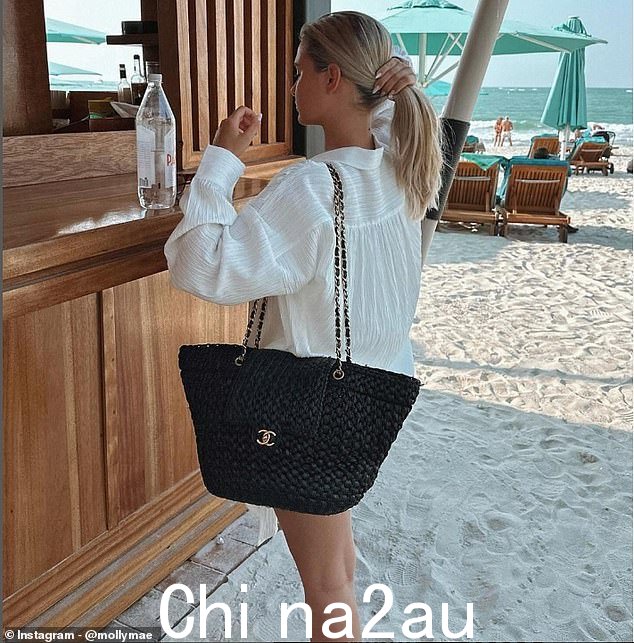 The former Love Islander showed off her love for all things designer as she hit the beach with her £10,000 black woven Chanel handbag and white bikini