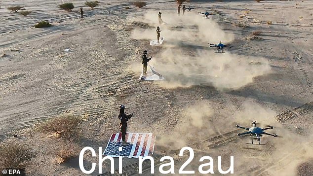 胡塞武装媒体中心还分享了武装分子在美国国旗上操作无人机的图像
