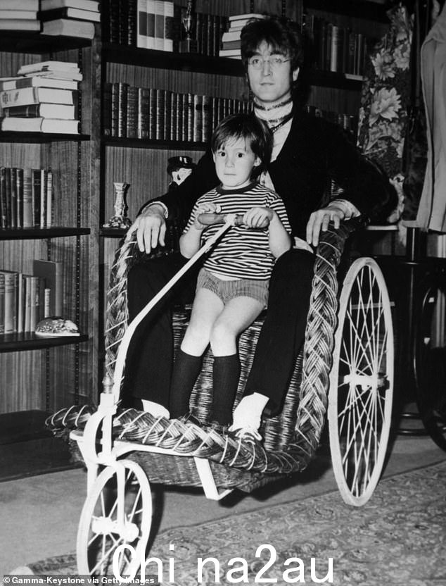 1965 年约翰·列侬与儿子朱利安在威布里奇的家中合影