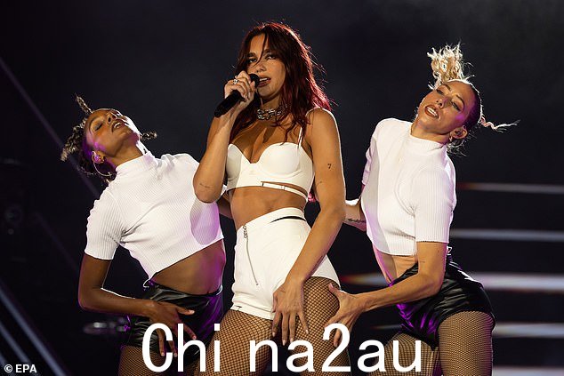 这位流行歌星在演绎一些热门歌曲时,穿着性感的白色短上衣和配套短裤,展示了她著名的身材