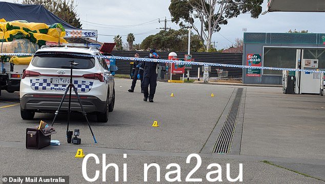 Evidence markers have been placed across the 7-Eleven car park