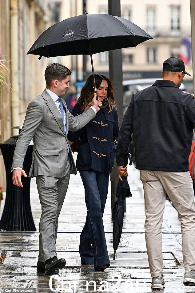 维多利亚·贝克汉姆 (Victoria Beckham) 冒着雨走出巴黎,准备周五在首都举行的时装周发布会