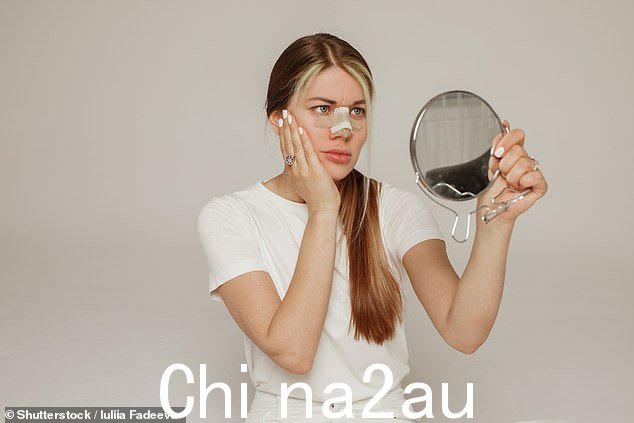 Stock image: 一位年轻女子在隆鼻后,鼻子上缠着绷带,手里拿着镜子,感到不满意