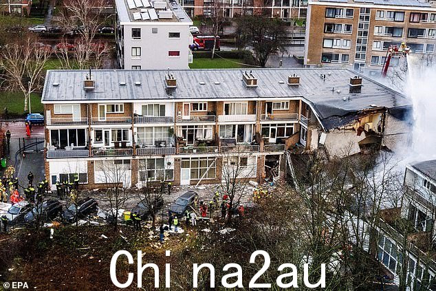 消防队员从地面和巨大的采摘车上扑灭大火,救护车将伤者送往医院和警察局直升机在空中盘旋” class=